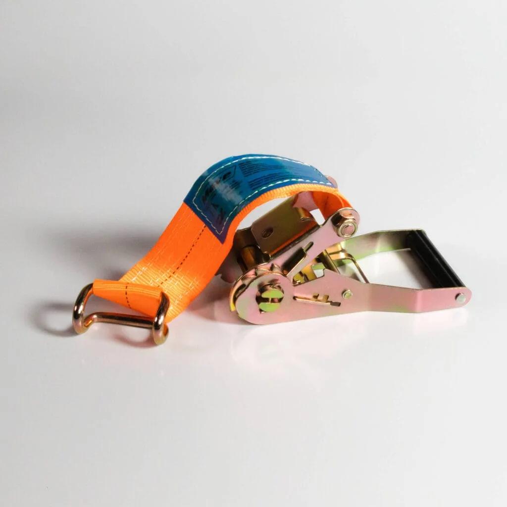 Imagem de uma catraca sider laranja com etiqueta azul sobre uma superfície branca.